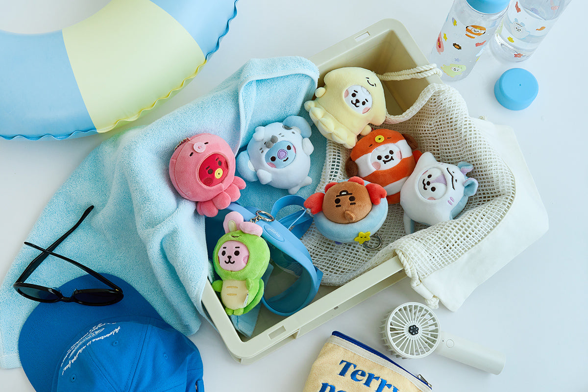 All seven BT21 BABY OCEAN FRIENDS mini doll keyrings in sea-creature costumes, with display props